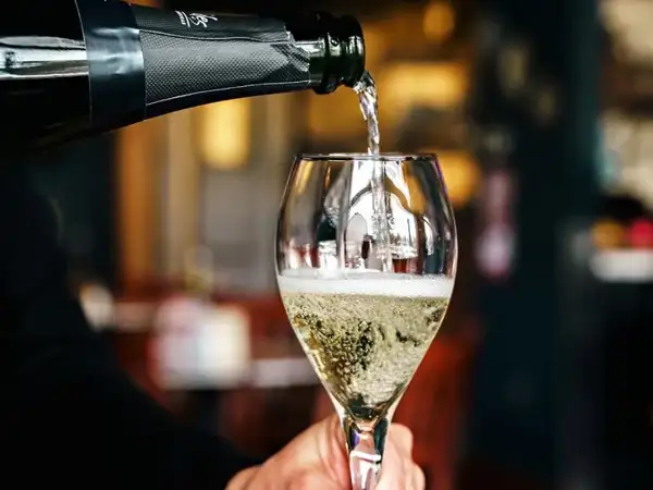Pouring a glass of champagne. 