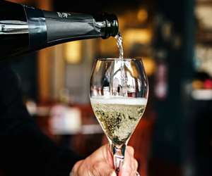 Pouring a glass of champagne. 