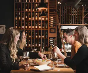 Guests enjoying a meal with wine at Flights. 