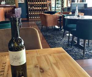 Wine bottle being featured in the dining room at Bistro Colette restaurant.