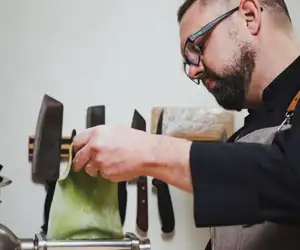 Chef preparing fresh pasta dish. 